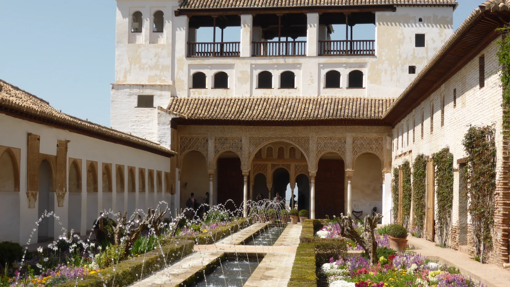 Fotografie van de Patio de la Acequia in de Generalife, met een lang waterkanaal en fonteinen.